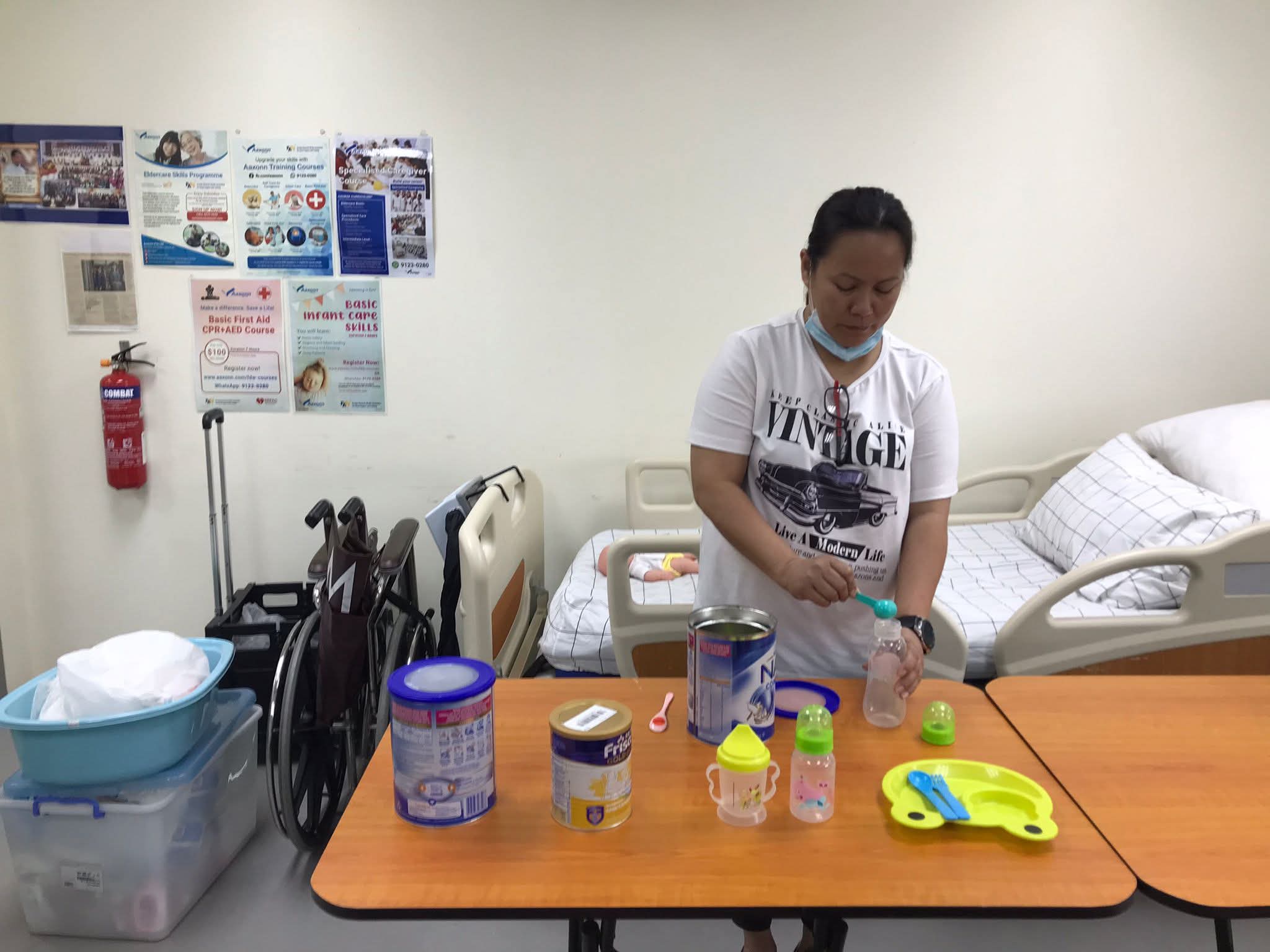 Filipino helper undergoing pediatric nutrition and baby bottle formula milk prep measurement training in KL
